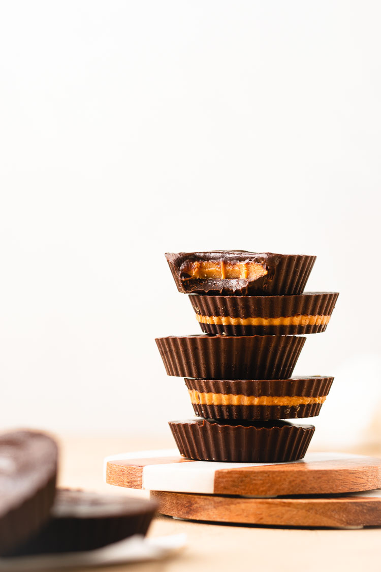 stack of peanut butter cups with a bite taken out of the top cup