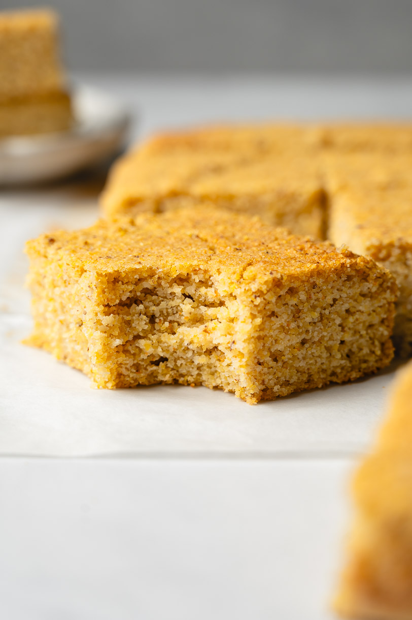 slice of almond flour cornbread with a bite taken out of it