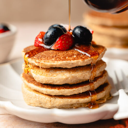 stack of tofu banana pancakes with maple syrup poured on top