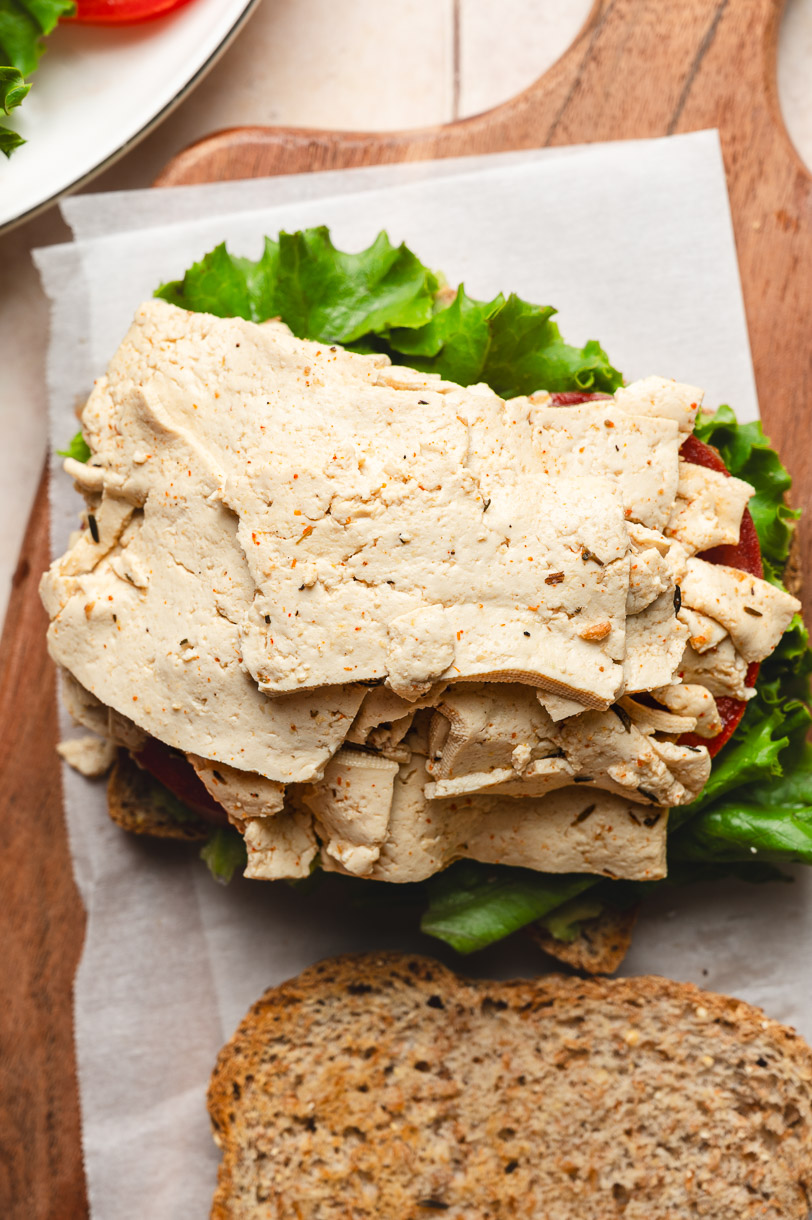 vegan tofu deli meat in open sandwich