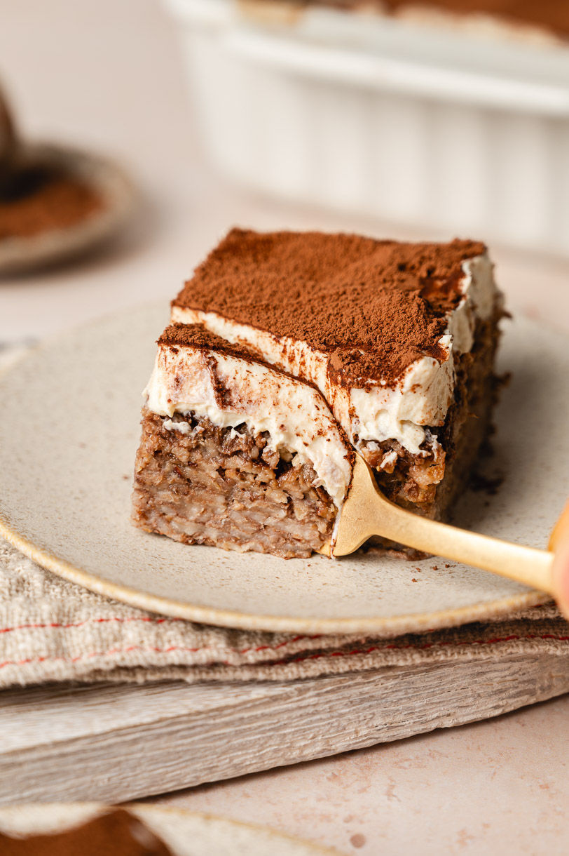 a bite being taken out of a slice of tiramisu baked oatmeal